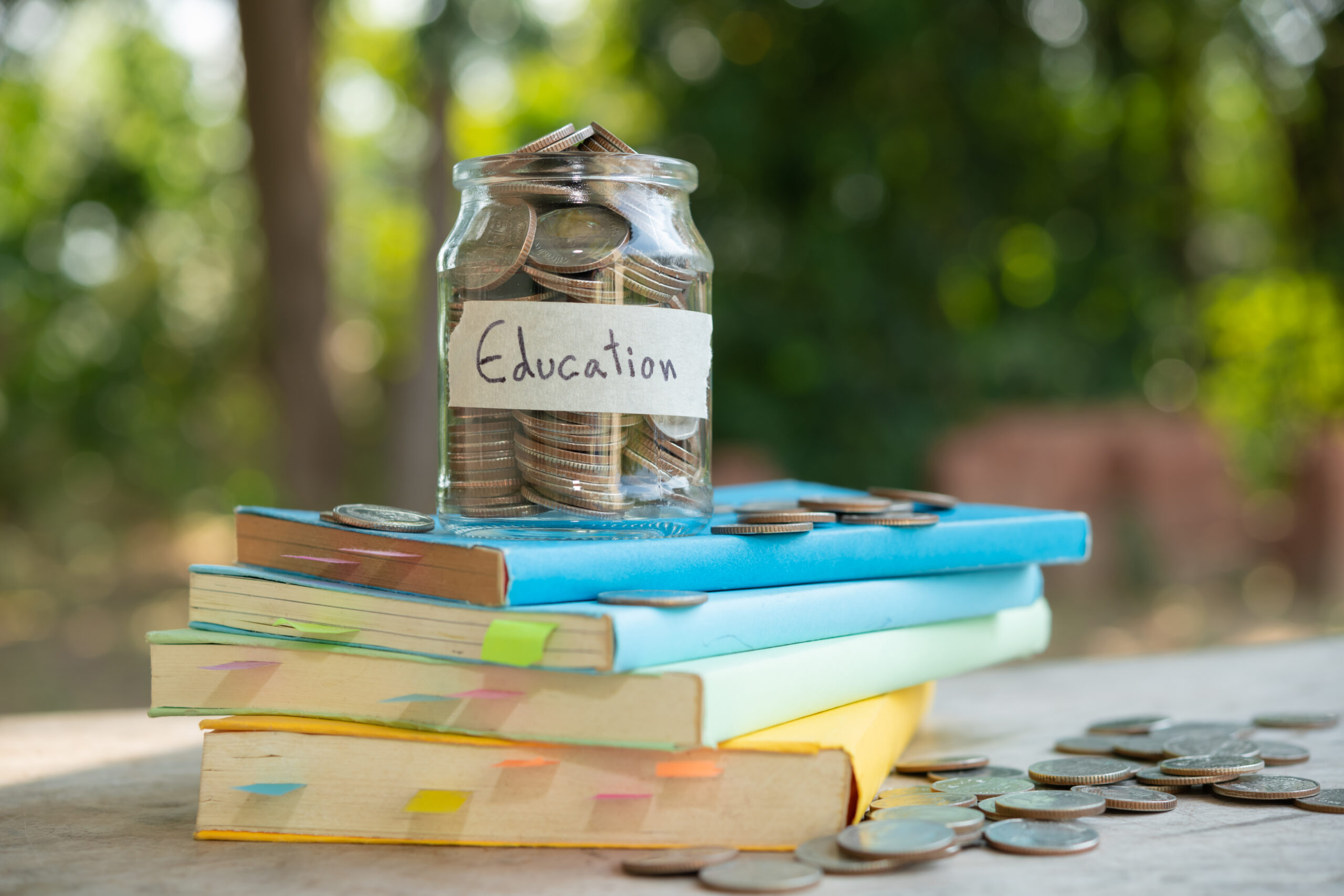 putting money coins saving in glass bottle for concept investmen